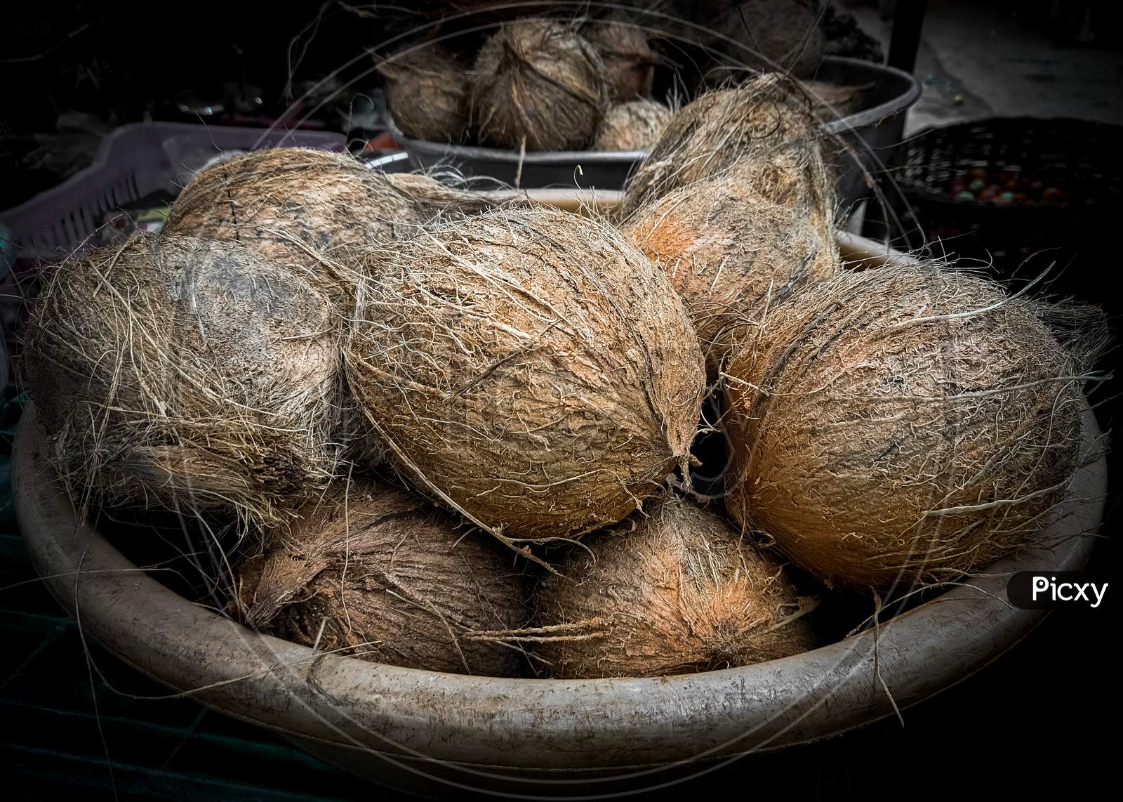 Collection of peeled coconuts for sale in the market.