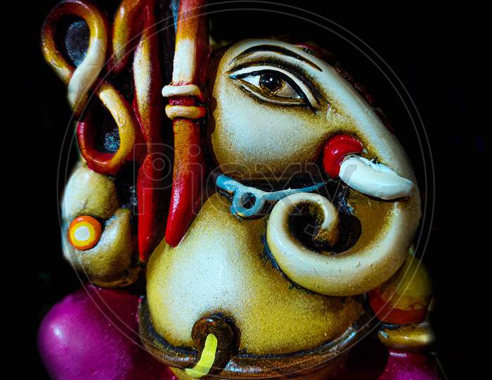 Beautiful, Colorful Artistic Figurine Of Lord Ganesha,Hindu God In Black Background.Elephant Head