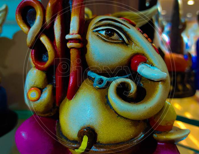 Beautiful And Colorful Artistic Figurine Of Lord Ganesha, Hindu God In Black Background.