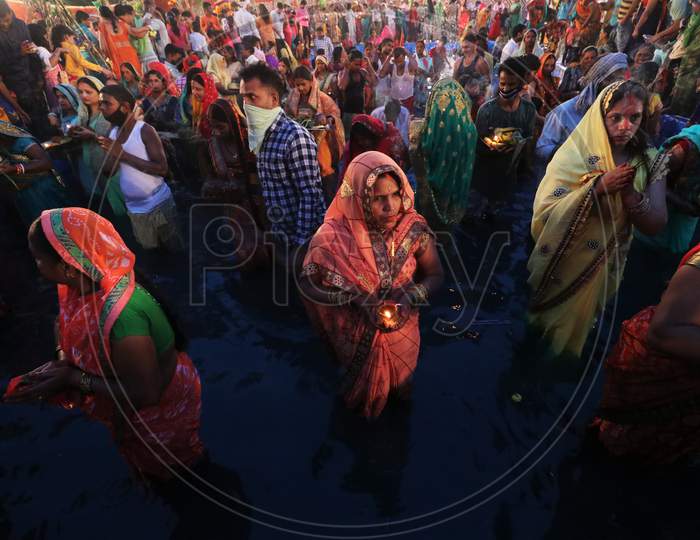 Hindu devotees worship the Sun god in an artificial pond during the religious festival of Chhath Puja, amid the spread of the coronavirus disease (COVID-19), in Mumbai, India on November 20, 2020.