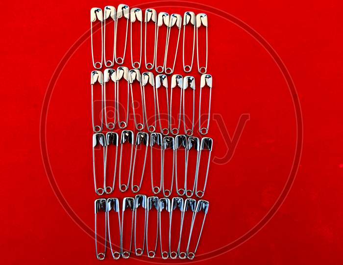 Series Of Safety Pins Are Arranged Like Rectangle Shape