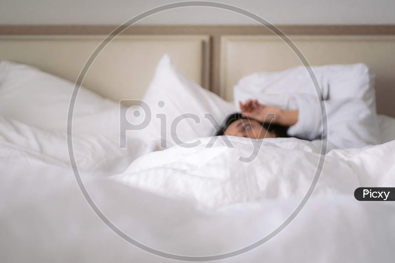 Macro Closeup To Texture And White Blanket With Woman Layig In Bed Out Of Focus. Intentional Blur