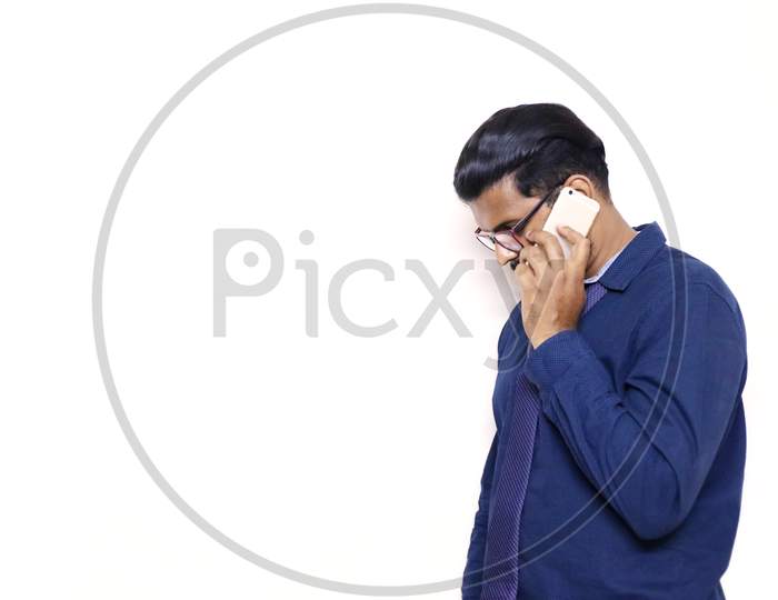 Businessman Calling Over Phone With Mobile In A Blue Suit