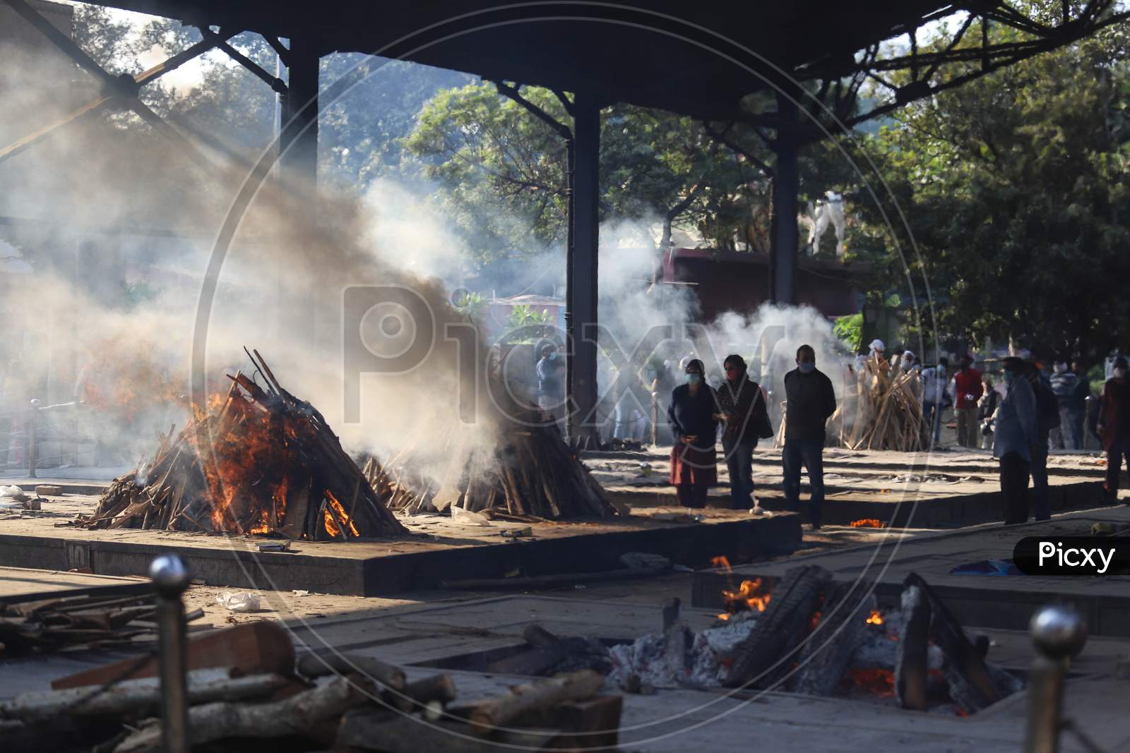 A relative performs final rituals for Covid-19 victim at Nigambodh Ghat crematorium, on November 21, 2020 in New Delhi, India. India records 46,232 fresh coronavirus cases, 564 COVID-19 deaths, and 49,715 one-day recoveries in the last 24 hours, shows government data.