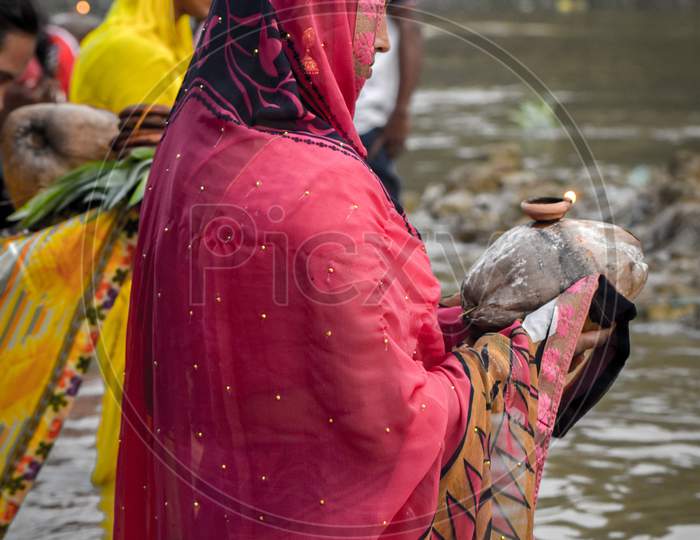 A woman offering pray in Chath puja