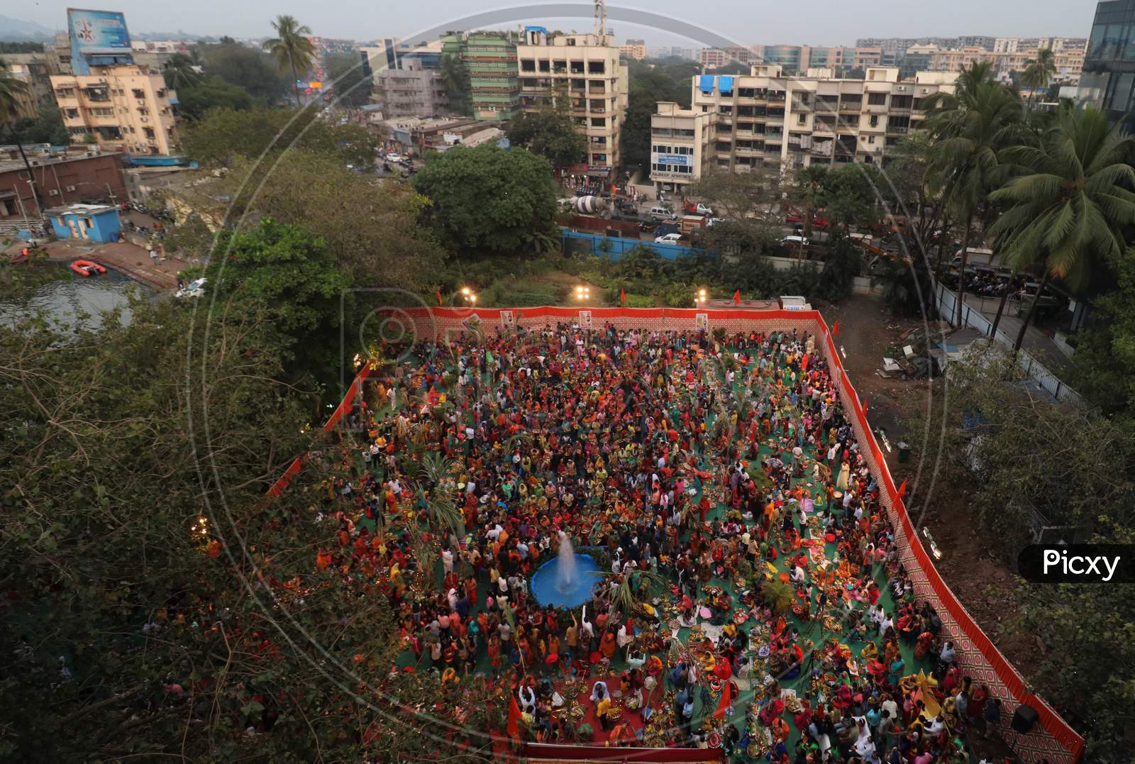Hindu devotees worship the Sun god in an artificial pond during the religious festival of Chhath Puja, amid the spread of the coronavirus disease (COVID-19), in Mumbai, India on November 20, 2020.