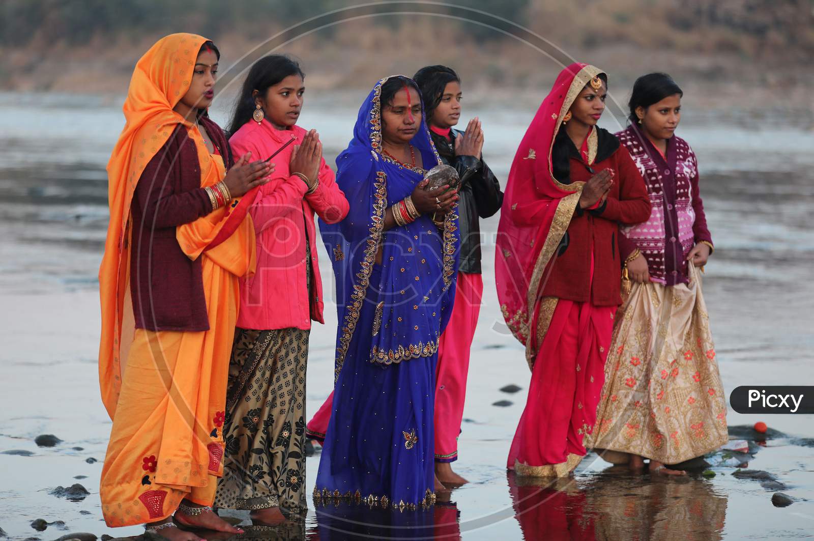 Devotees perform rituals during 'Chhath Puja' celebrations, on the banks of River Tawi in Jammu, Saturday, Nov. 21, 2020.