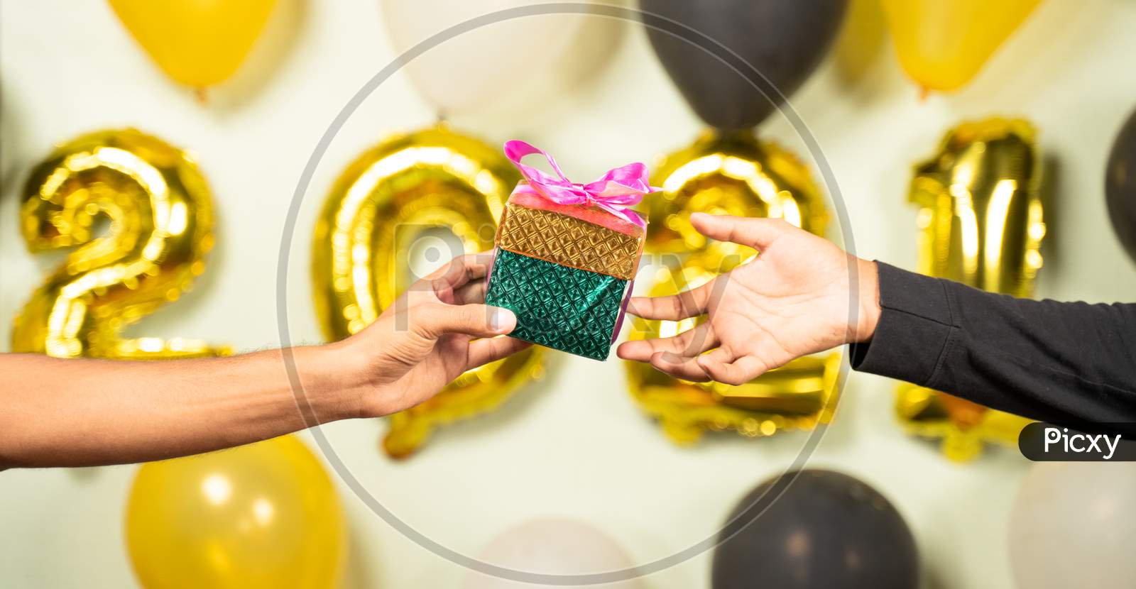 Close Up Of Hands Giving Present Gift Box In 2021 New Year Celebration On Decorated Background - Concept Of Gift Sharing On New Year Holydays.