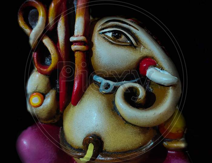Beautiful And Colorful Artistic Figurine Of Lord Ganesha, Hindu God In Black Background.