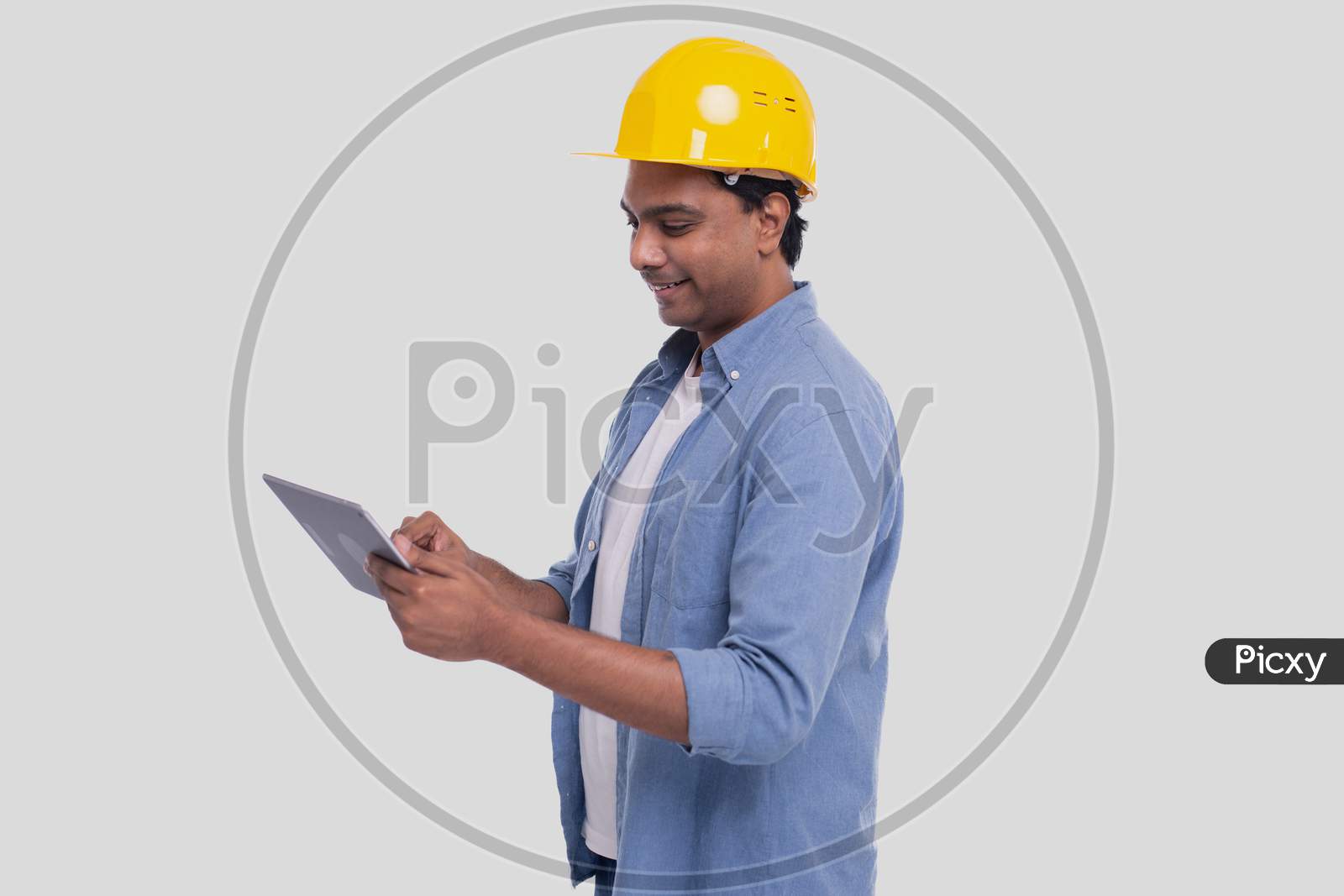 Construction Worker Holding Tablet In Hands. Man Using Tablet. Architect Holding Tablet. Yellow Hard Helmet. Worker Isolated
