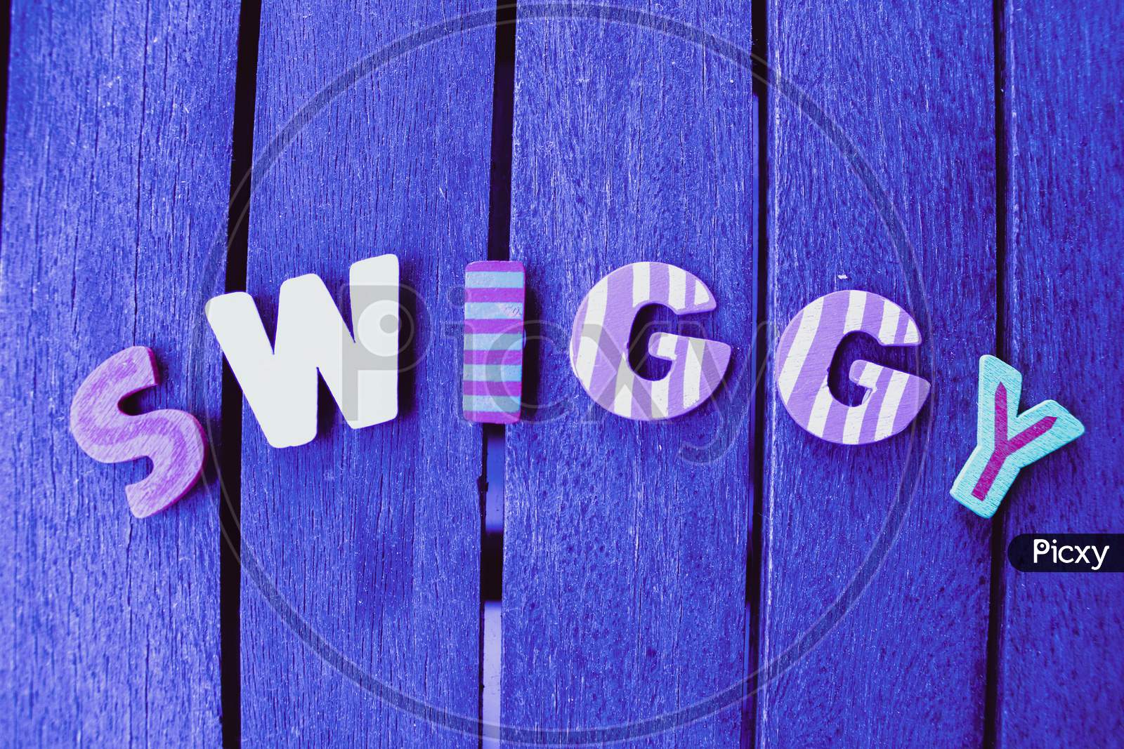 Swiggy Letters App On Wood Background
