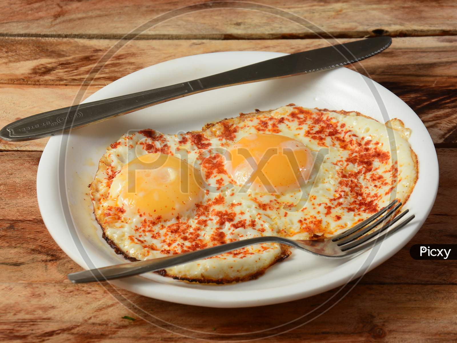 Indian Style Tasty And Healthy Double Egg Half Fried Omelet On A Wooden Rustic Background. Selective Focus