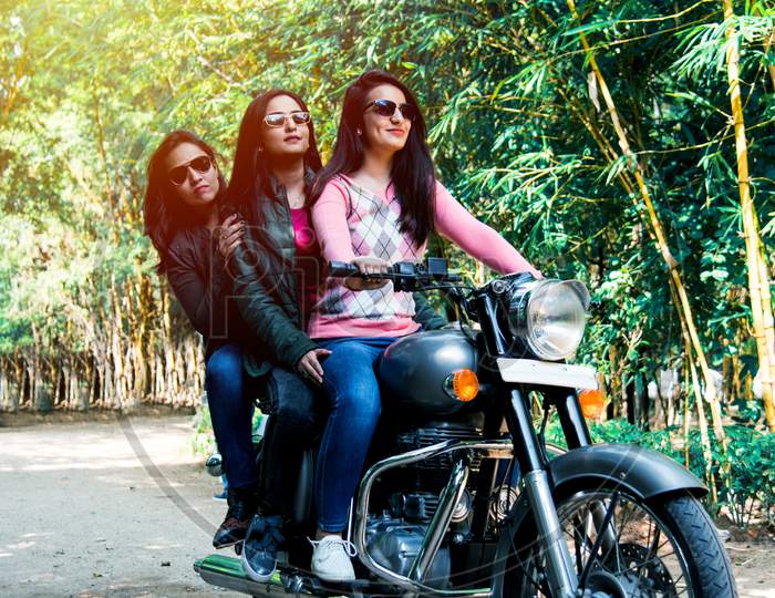 Happy Asian Indian Young Woman Or Female Friends Riding On Motorcycle Or Motorbike