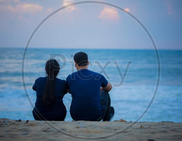 Couple Sitting In Beach