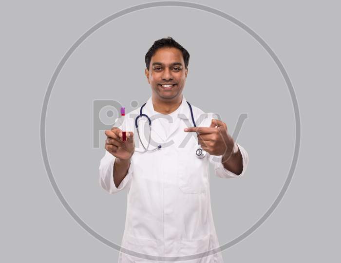 Indian Man Doctor Pointing At Blood Tube Analysis. Science, Medical Concept. Isolated