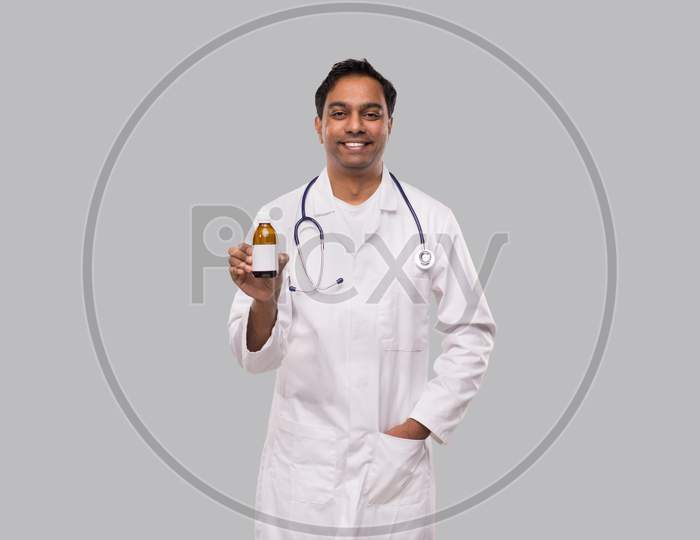 Indian Man Doctor Holding Cough Syrup Isolated