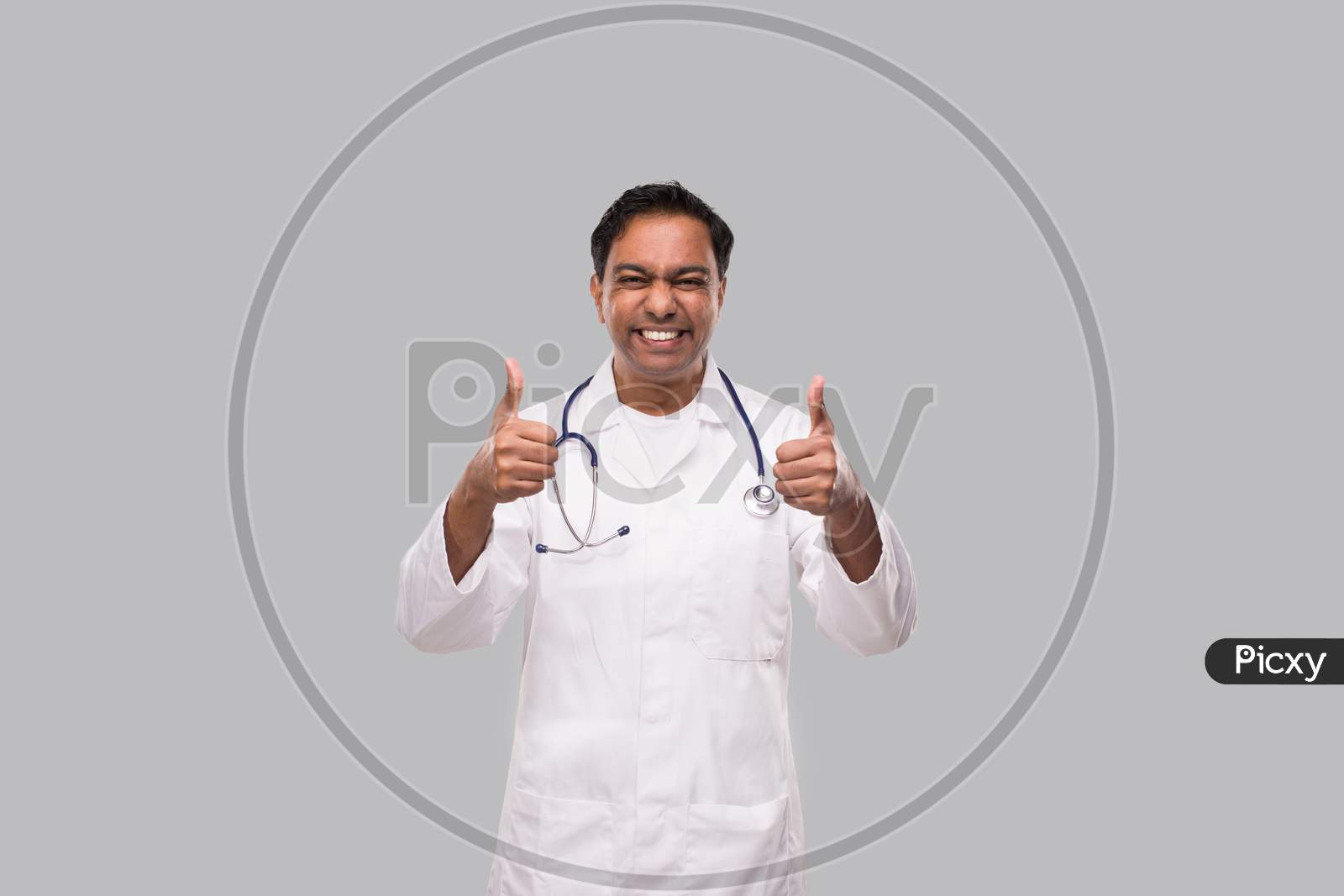 Indian Man Doctor Showing Thumb Up Both Hands Smilling. Isolated