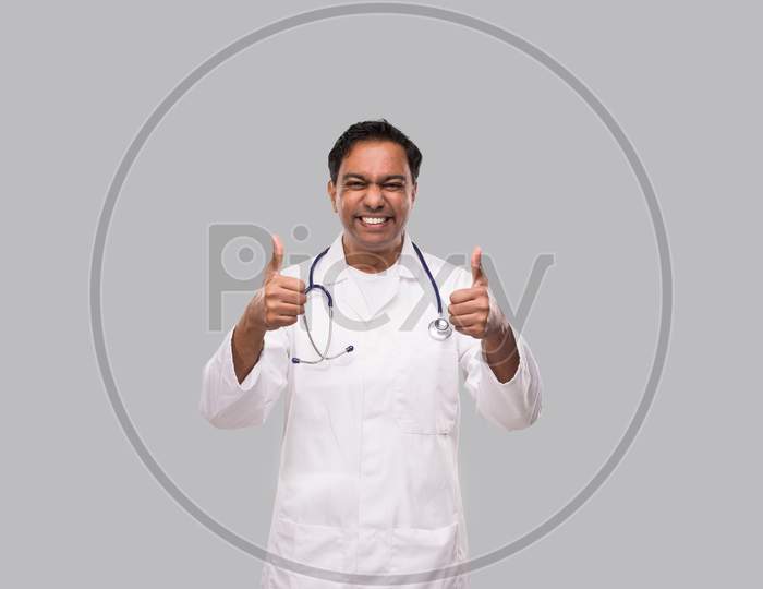 Indian Man Doctor Showing Thumb Up Both Hands Smilling. Isolated