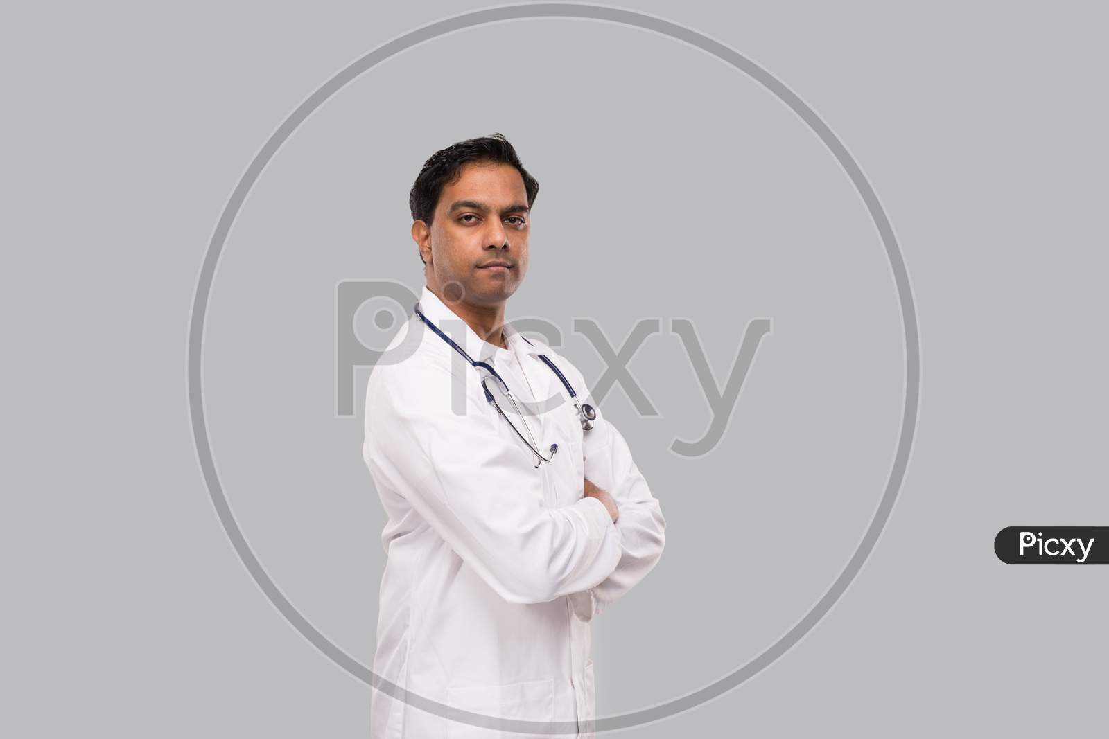 Indian Man Doctor Seroius Face Hands Crossed Isolated. Healthy Life, Medicine Concept.