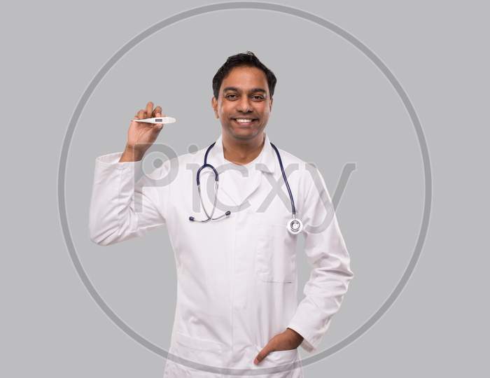 Doctor Showing Thermometer Isolated. Indian Man Doctor Smiling With Thermometer In Hands. Healthy Life, Doctor, Virus Concept