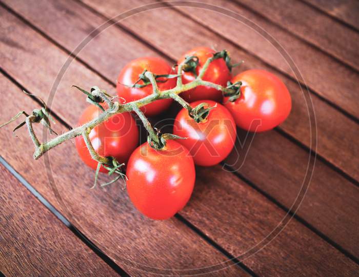 Red Tomatoes On Wood Background