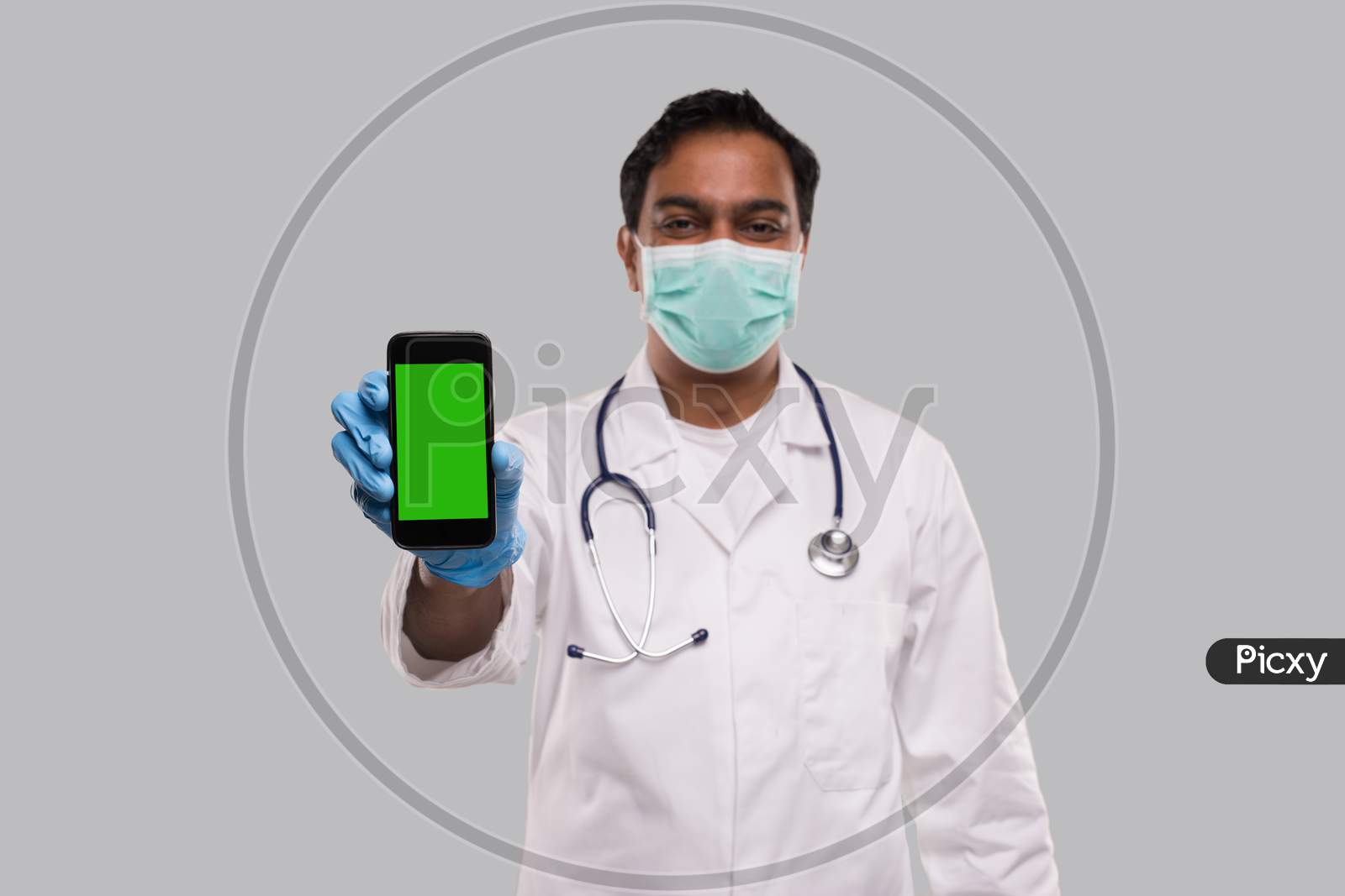 Doctor Showing Phone Wearing Medical Mask And Gloves. Indian Man Doctor Technology Medicine At Home. Phone Green Screen Close Up Isolated