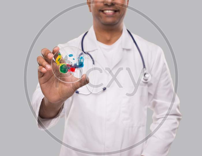 Doctor Holding Petri Dish Smilling Isolated Close Up. Medicine, Science Concept