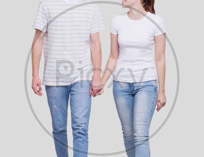 Young Cute Couple Walking Together Holding Hands Isolated