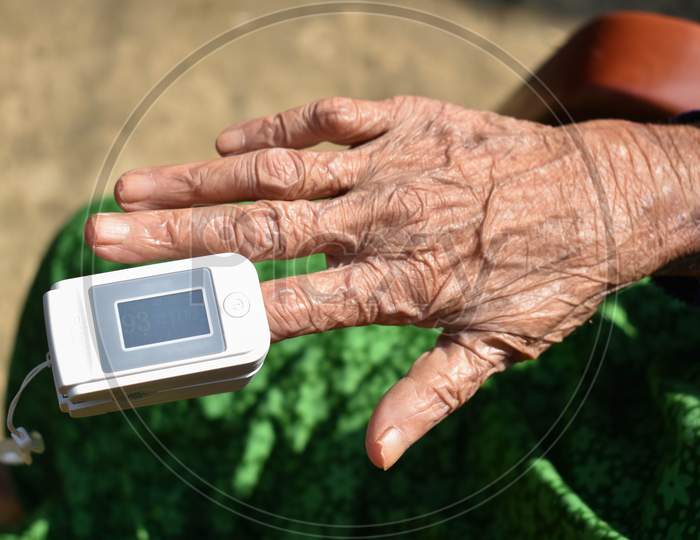 Pulse Oximeter Attached With Index Finger Of An Old Lady .