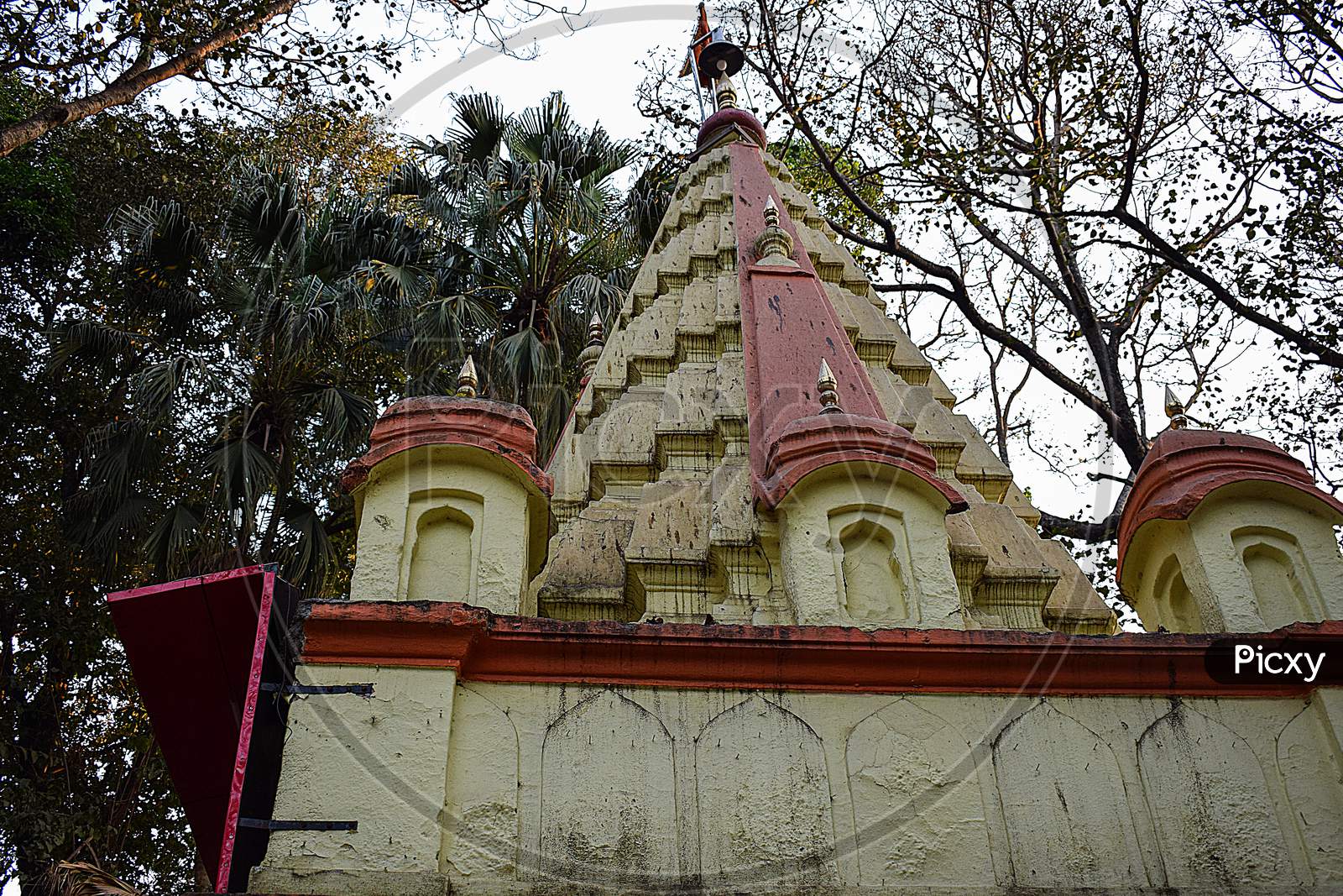 Picture Of Traditional Hindu Temples Painted With Yellow And Red Color Peak
