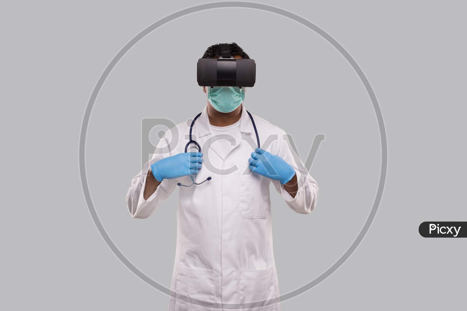Doctor Wearing Vr Glasses, Medical Mask And Gloves Holding Stethoscope Isolated. Indian Man Doctor Online Medicine