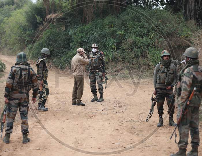 Security personel stand gurad beside an underground tunnel near the international border in Samba sector, suspected to have been used by terrorists killed in a recent encounter in Nagrota, in Jammu district, Sunday, Nov. 22, 2020.