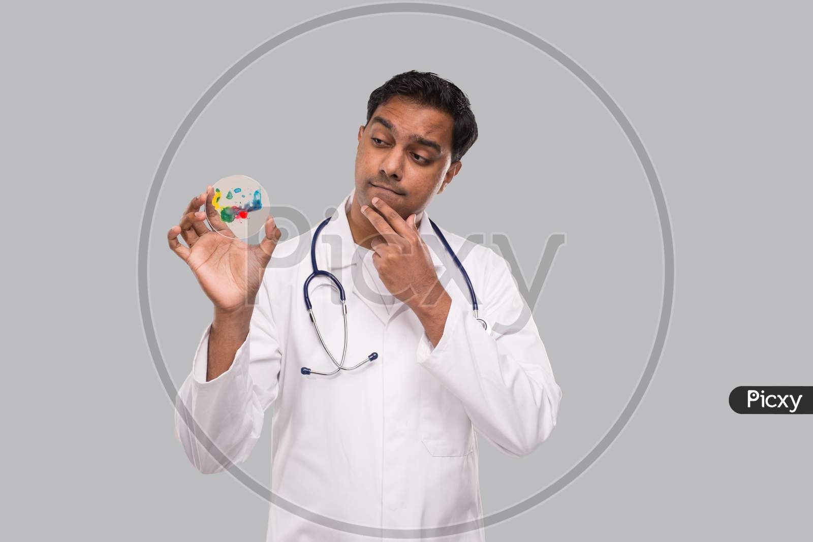 Indian Man Doctor Examing Petri Dish Isolated. Medicine, Science Concept