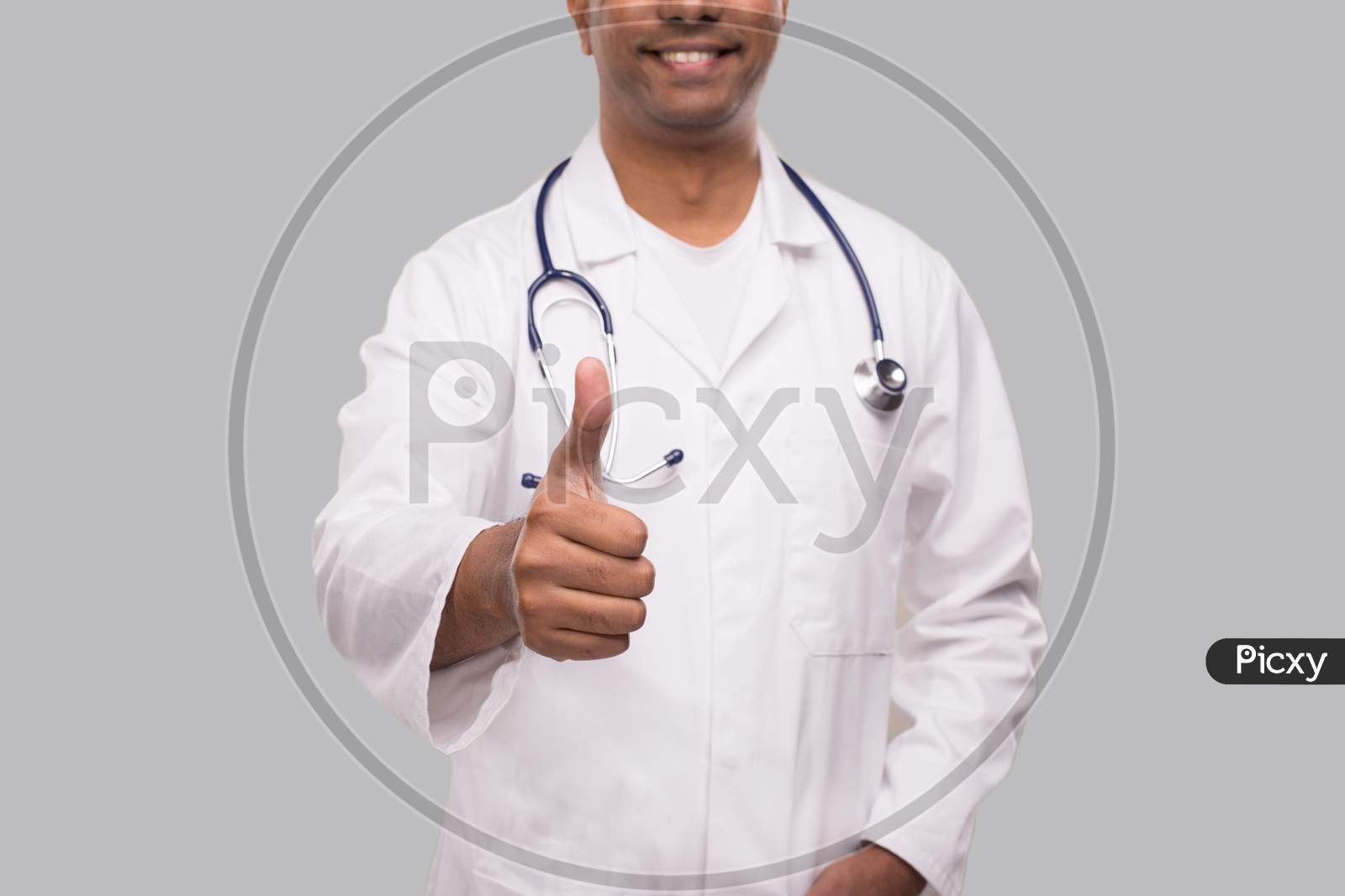 Doctor Showing Thumb Up Smilling Close Up. Isolated Indian Man Doctor