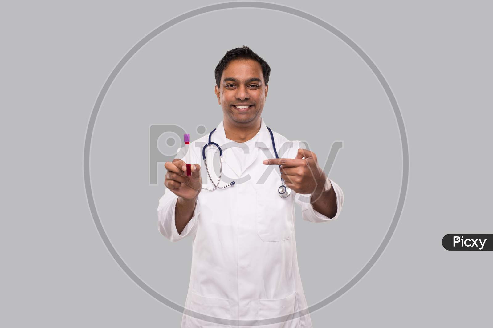 Indian Man Doctor Pointing At Blood Tube Analysis. Science, Medical Concept. Isolated