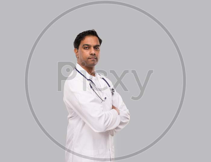 Indian Man Doctor Seroius Face Hands Crossed Isolated. Healthy Life, Medicine Concept.