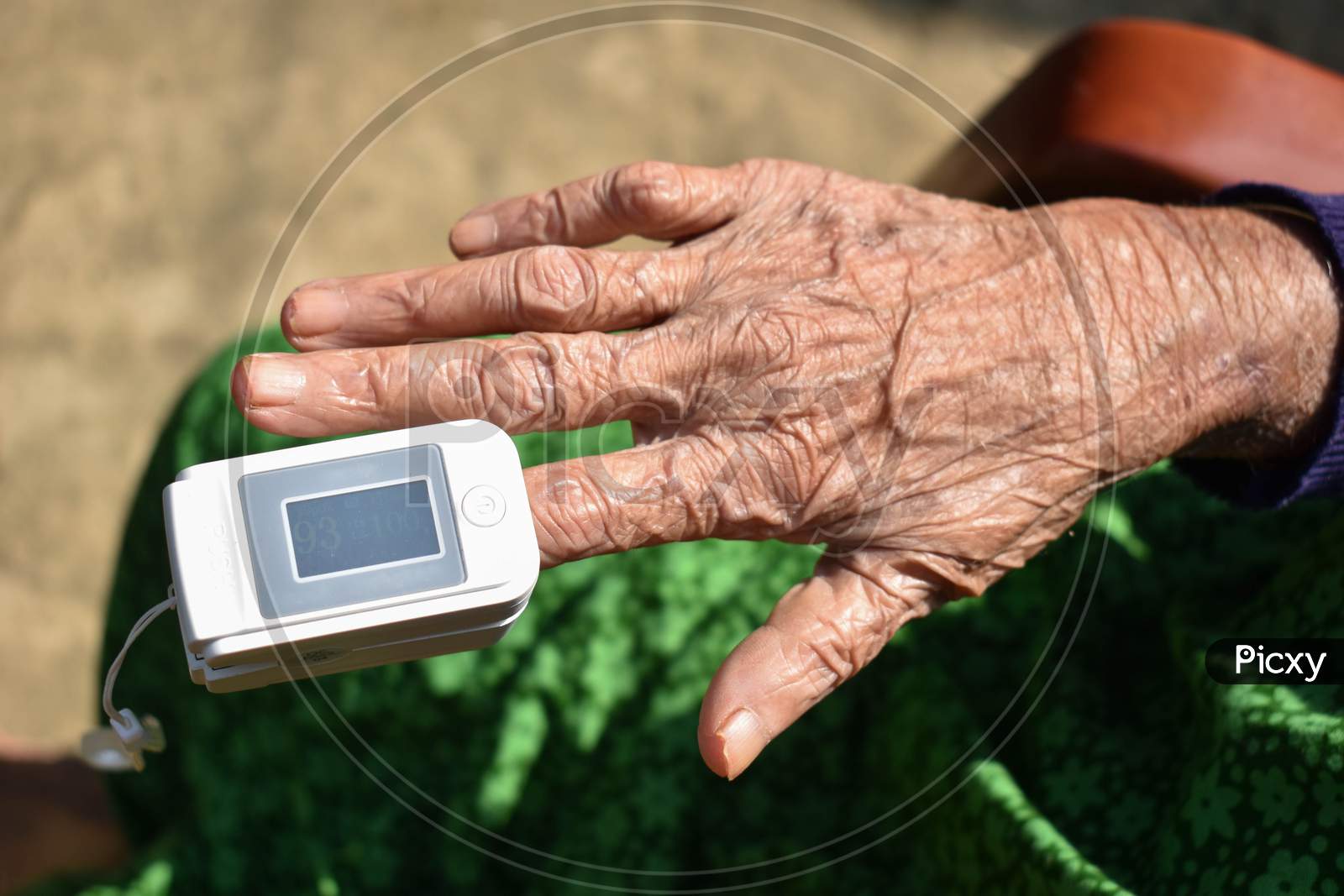 Pulse Oximeter Attached With Index Finger Of An Old Lady .