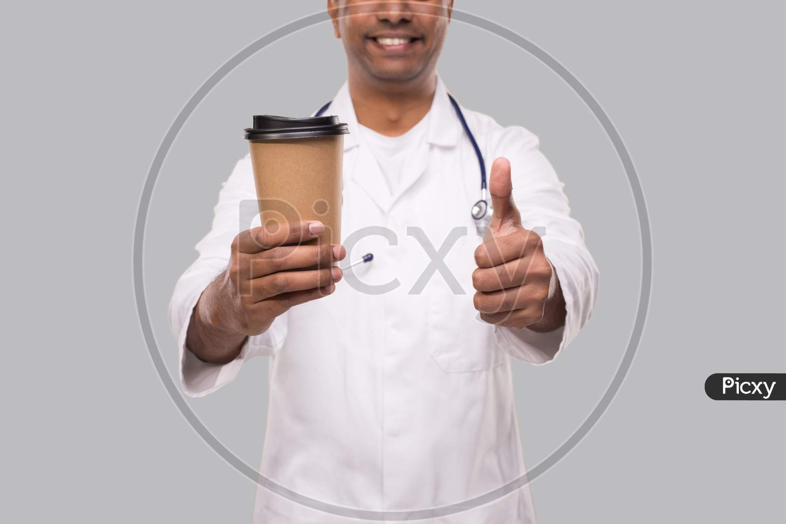 Man Doctor Holding Coffee Take Away Cup Smiling Close Up Isolated. Indian Doctor Holding Coffee To Go Cup.