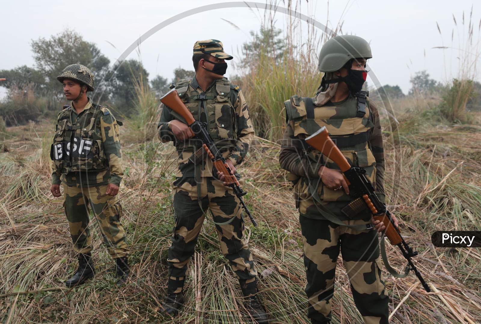 Security personnel stand guard beside an underground tunnel near the international border in Samba sector, suspected to have been used by terrorists killed in a recent encounter in Nagrota, in Jammu district, Sunday, Nov. 22, 2020.