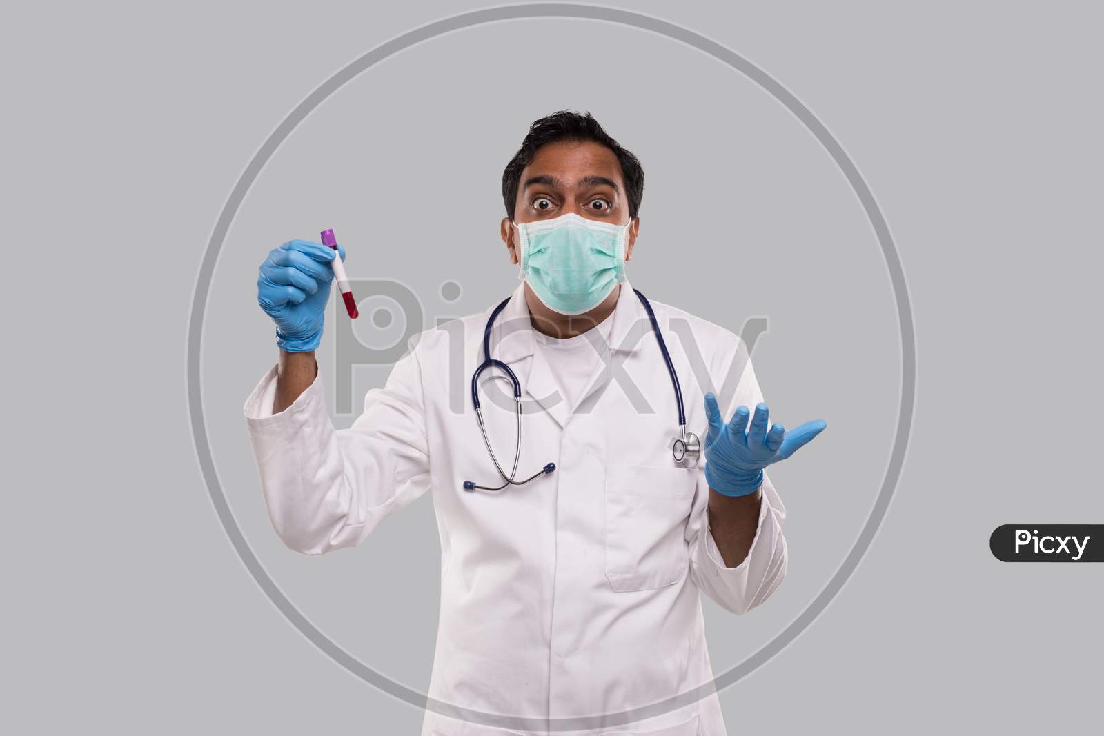 Doctor Surprised Holding Blood Tube Analysis Wearing Medical Mask And Gloves. Indian Man Doctor Science, Medical Concept. Isolated.