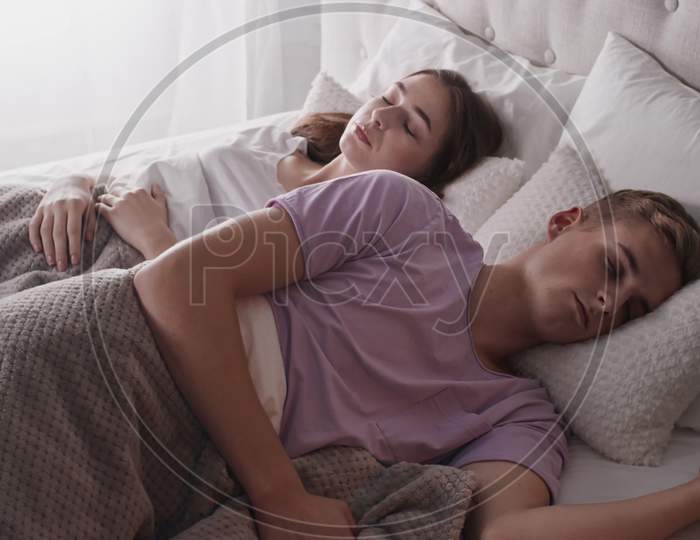Couple Sleeping In Bed Cuddle. Girl Hugging Man. Couple In Bed. Shot On Red
