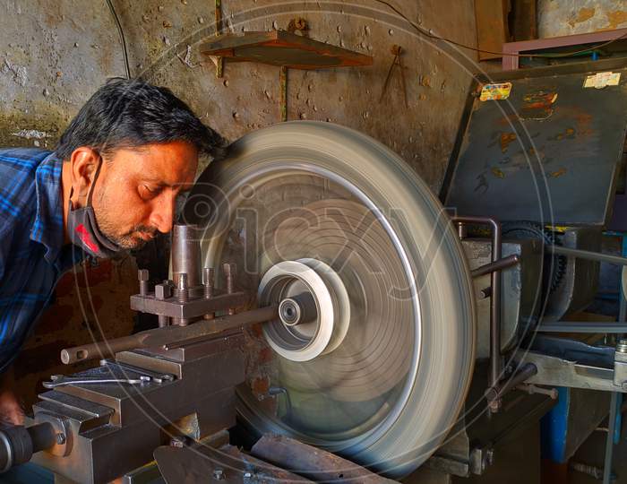 November 2020- Mahroli, Jaipur, India / Close Up View Of Bike Tyre, Fitting On Lathe Machine For Repairing.