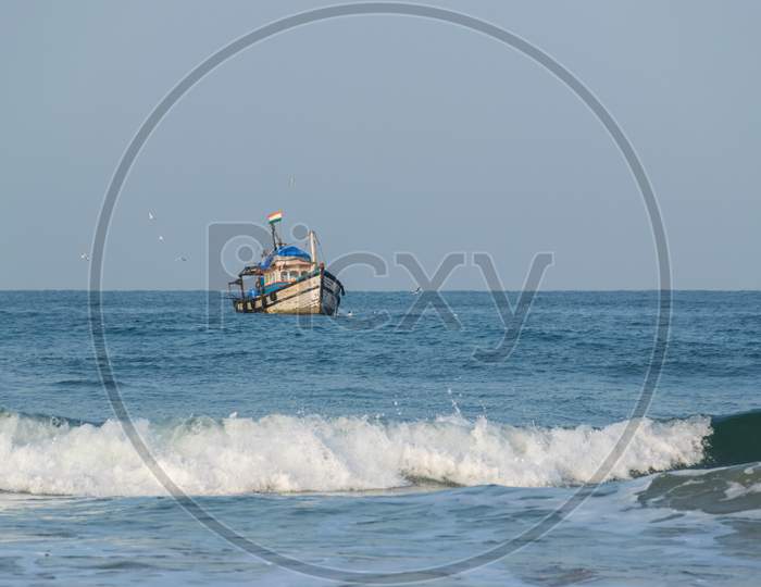 A Fishing Boat Sailing Towards The Coast Of Arabian Sea In Goa, India