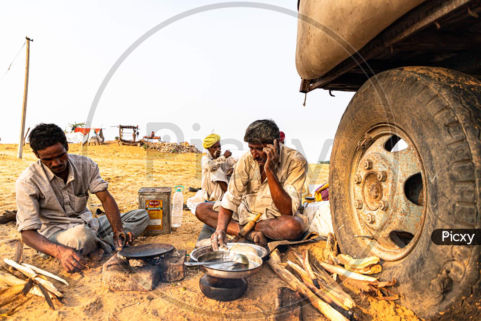 Nomadic Rajasthani Man Making Food At Pushkar Camel Festival.