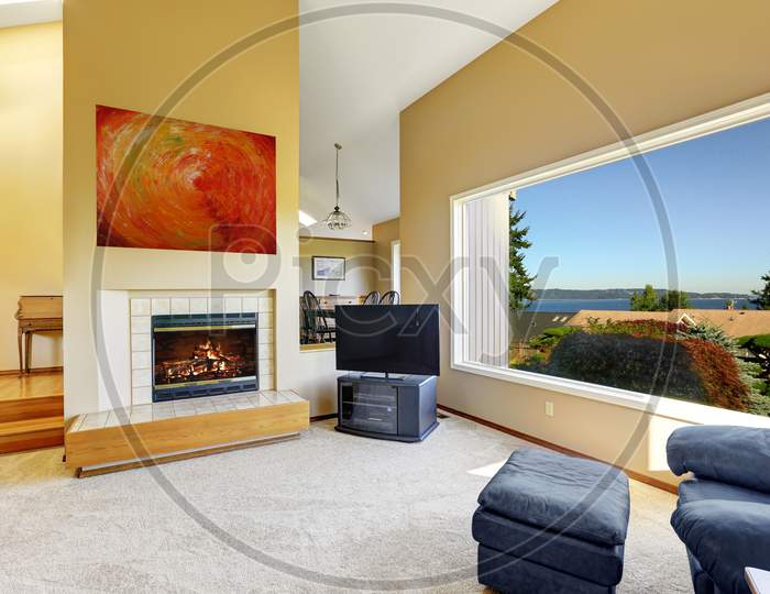 Luxury Living Room With High Vaulted Ceiling And Large Window With Scenic Bay View