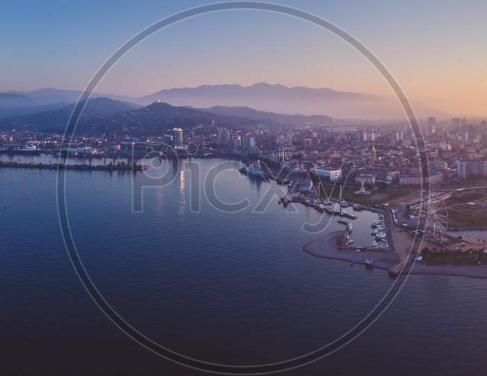 Dramatic Wide Hdr Aerial Panoramic View Of Batumi City Port And Sightseeing Attrcation With Real Estate Buildings In The Background During The Sunset. Georgia Travel Destination