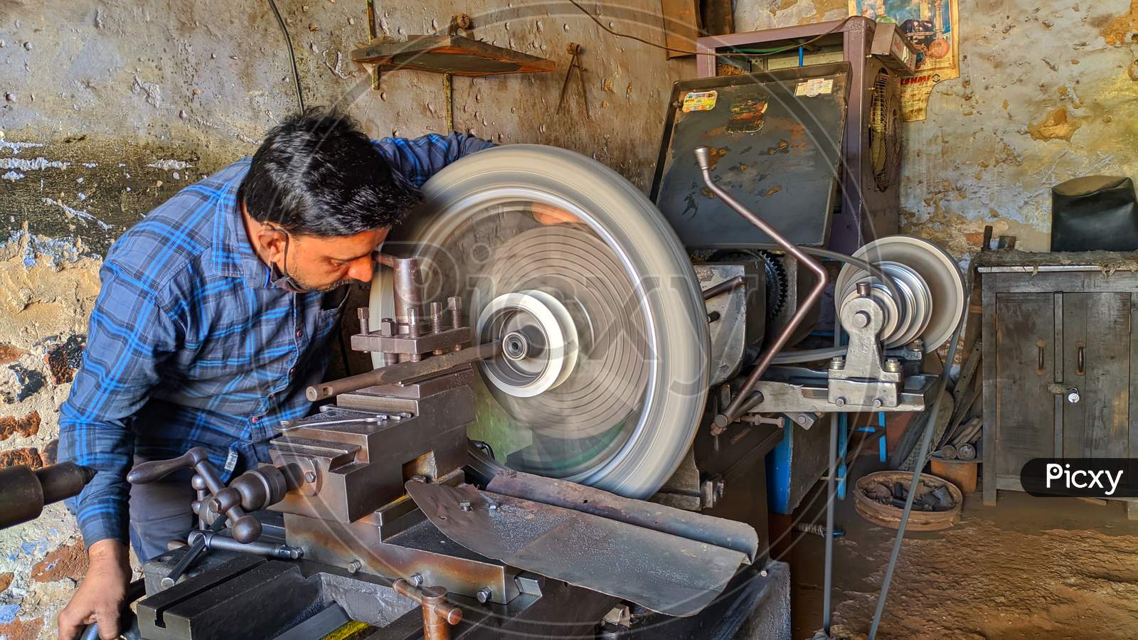 November 2020- Mahroli, Jaipur, India / Close Up View Of Bike Tyre, Fitting On Lathe Machine For Repairing.