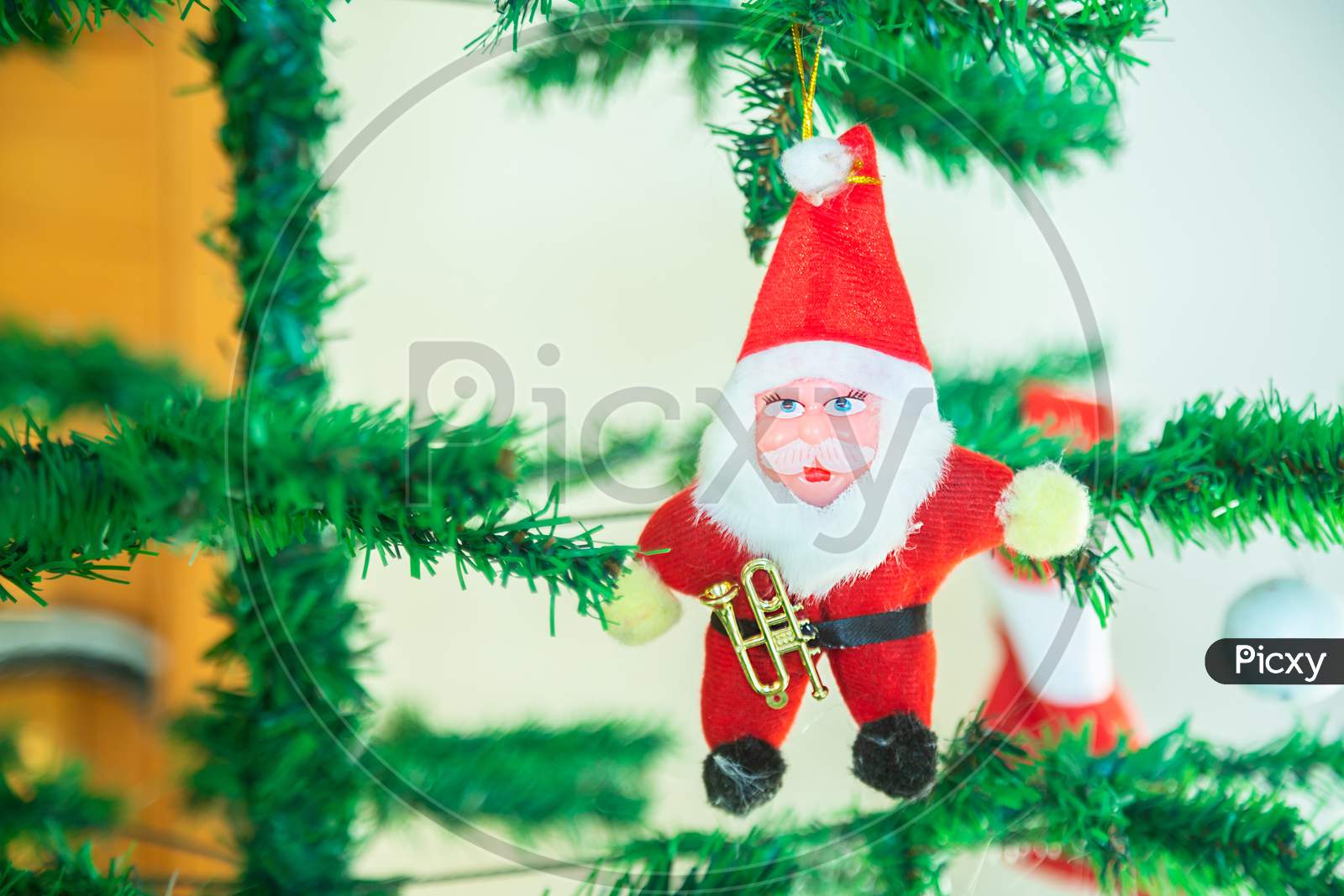 Cute Santa Claus Toy Hanging On Tree, Christmas Background, Decoration, Celebration, Greetings, Copy Space.