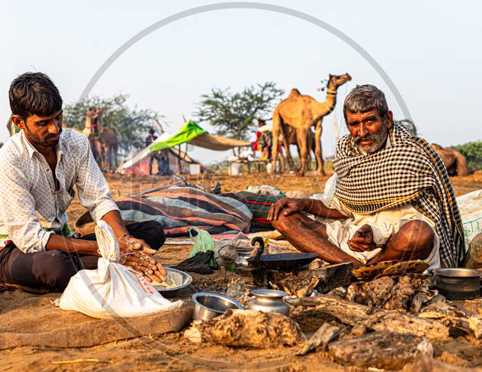 Cameleers Making Food At Pushkar Camel Festival.