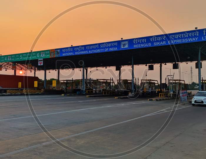 Side View Of Toll Tax On Nhai With Vehicle Barricade Scene.